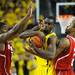 Michigan junior Tim Hardaway Jr. is fouled in the last seconds by North Carolina State senior Lorenzo Brown, right, as freshman Rodney Purvis stands by during the second half at Crisler Center on Tuesday night. Melanie Maxwell I AnnArbor.com